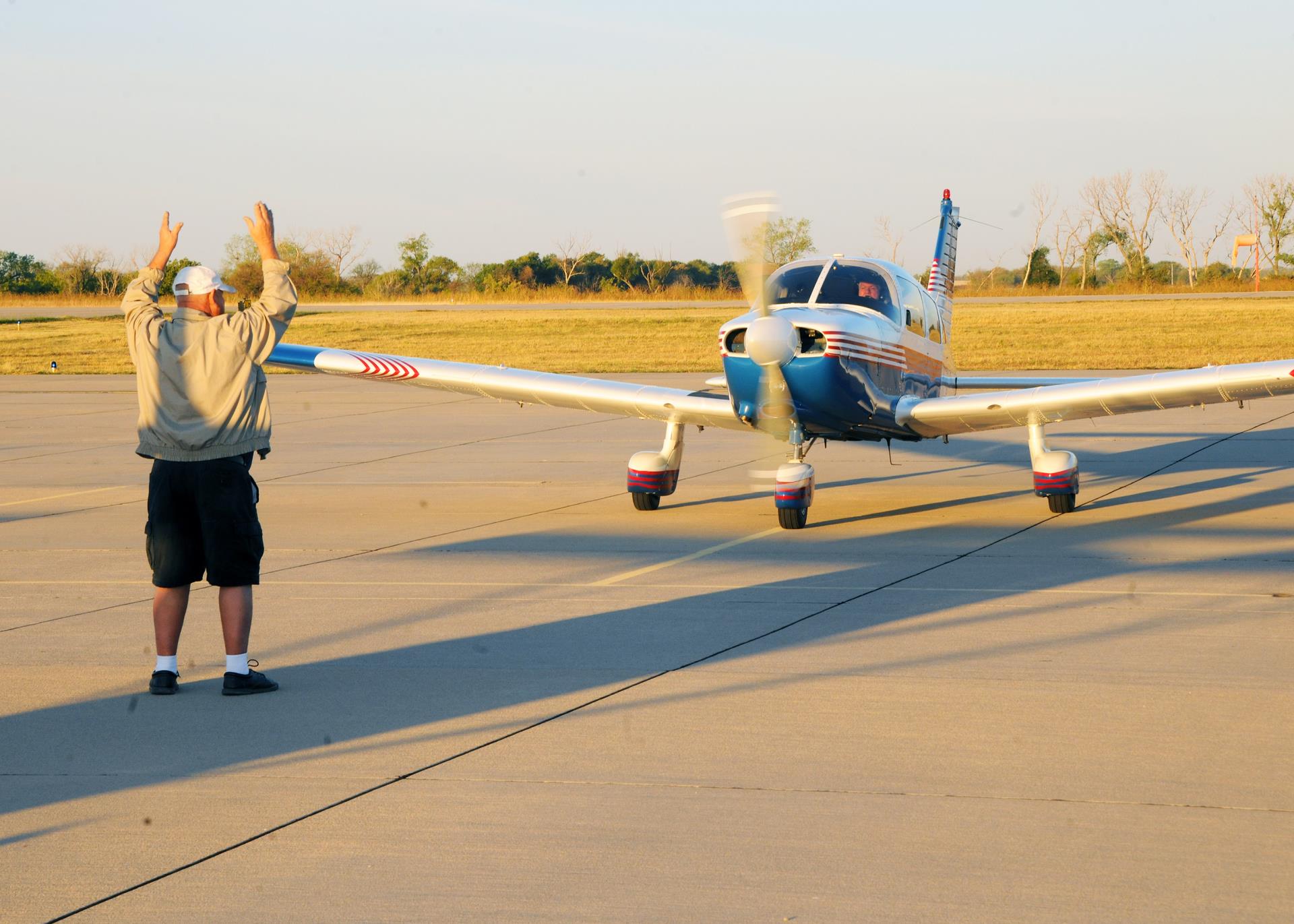 Man in front of airplane on the ground